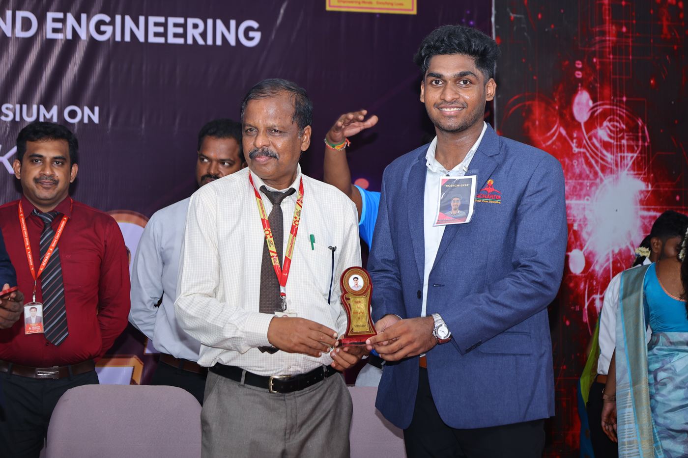 Receiving a memento on stage at the ACETCM 2K24 symposium